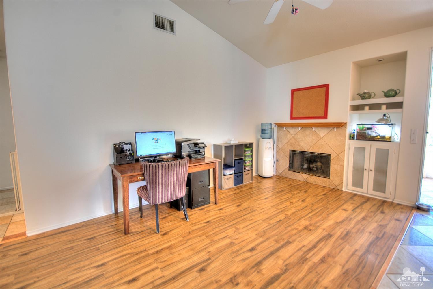 68237 Pasada Road Cathedral City, CA 92234 - Photo 9 of 30 a living room with furniture a fireplace and a table