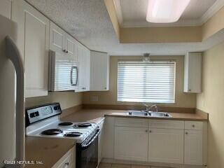 a kitchen with granite countertop cabinets stainless steel appliances and a window
