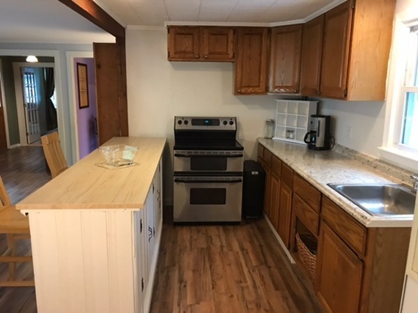 211 South Row Road Lunenburg, MA 01462 - Photo 6 of 19 a kitchen with a stove a sink and a microwave
