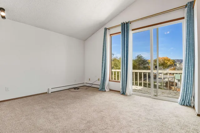 an empty room with a ceiling fan and a bathroom