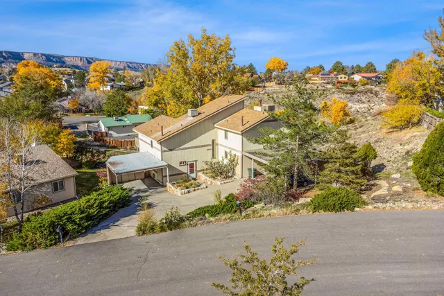 a view of garage with a car parked in front of it