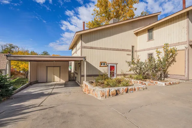 a view of a house with a wooden bench