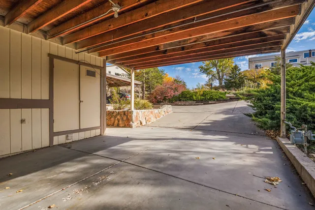 a view of staircase with wooden floor and fan