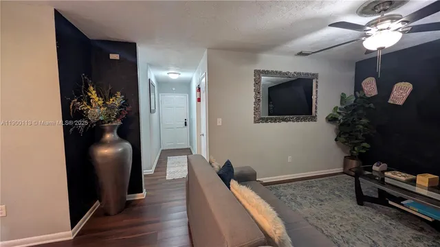 a hallway with furniture and a potted plant