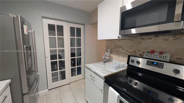 a kitchen that has a stove and a microwave