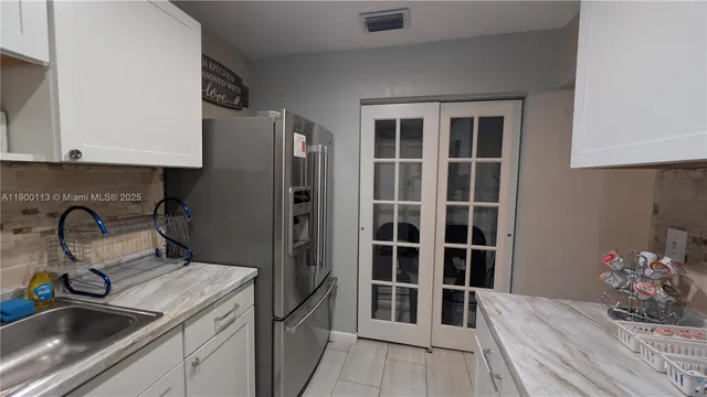 a kitchen with granite countertop a stove and a sink