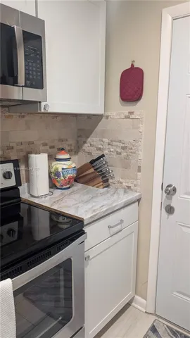 a kitchen with stainless steel appliances a refrigerator and cabinets