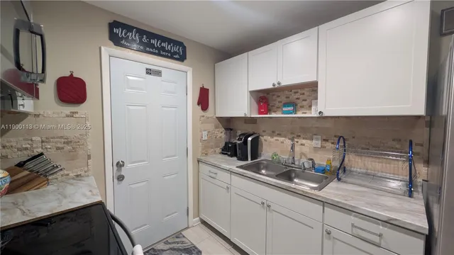 a kitchen with stainless steel appliances a refrigerator and cabinets
