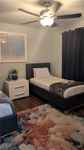 a bedroom with two beds and painted walls