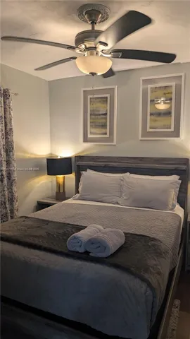 a bedroom with bed and window