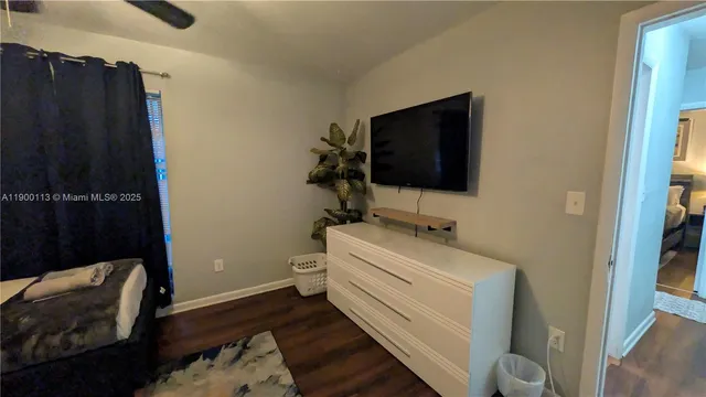 a view of wooden floor and cabinets in a room