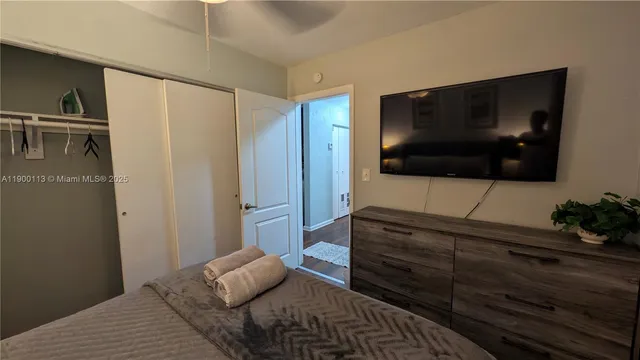 a bedroom with a bed and a television