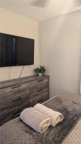 a living room with furniture a rug and a floor to ceiling window