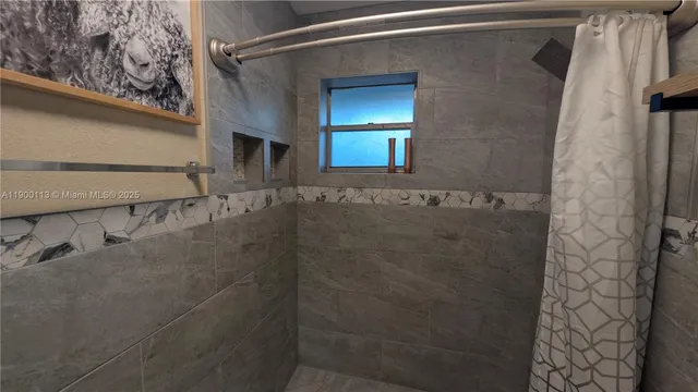 a living room with patio furniture and a potted plant