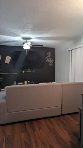 a living room with hard wood floors