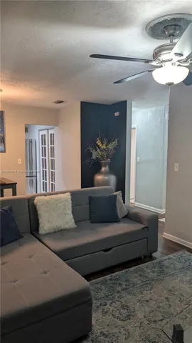 a living room with furniture and a large mirror