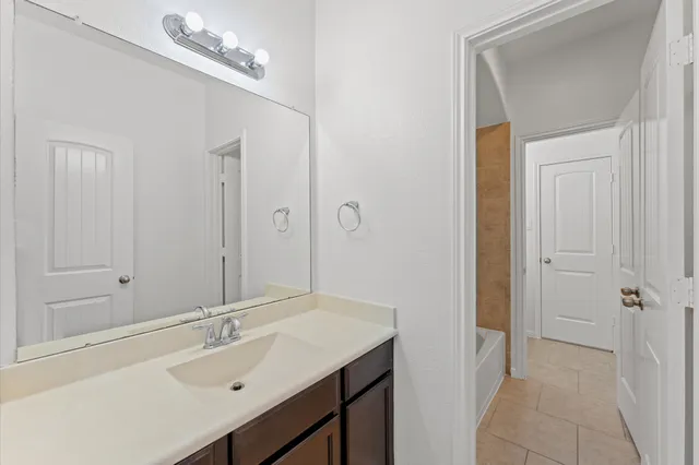 a bathroom with a sink a mirror and a shower