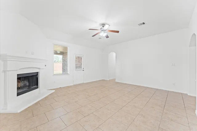 a view of empty room with fireplace