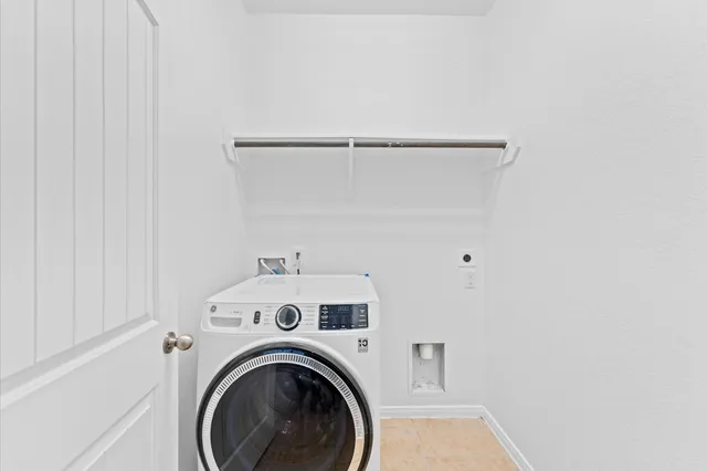 a view of storage and utility room with washer and dryer