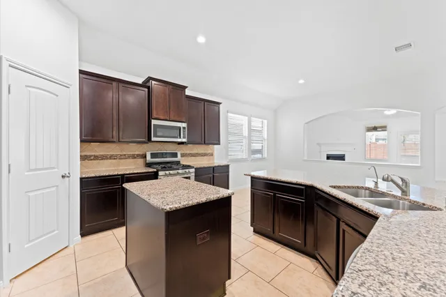a kitchen with a sink stove and microwave