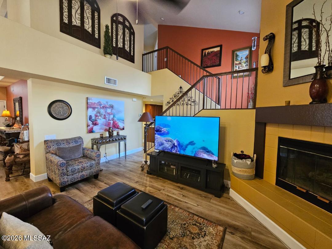 3130 West Star Ranch Trail Tucson, AZ 85742 - Photo 20 of 44 a living room with furniture gym equipment and a fireplace