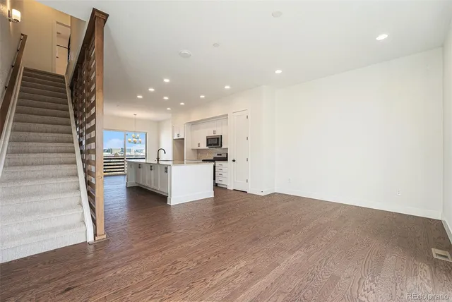 a bathroom with a granite countertop sink mirror and toilet