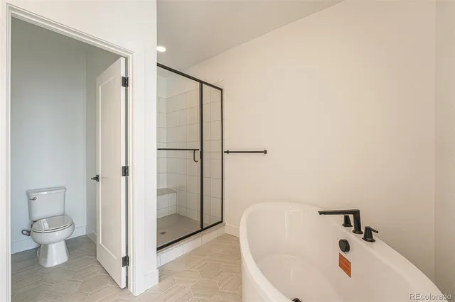 a bathroom with a granite countertop sink toilet a shower and a mirror