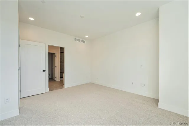 a bathroom with a granite countertop sink a toilet and a mirror