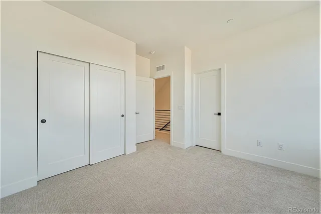 a view of a balcony with two chairs and a wooden floor