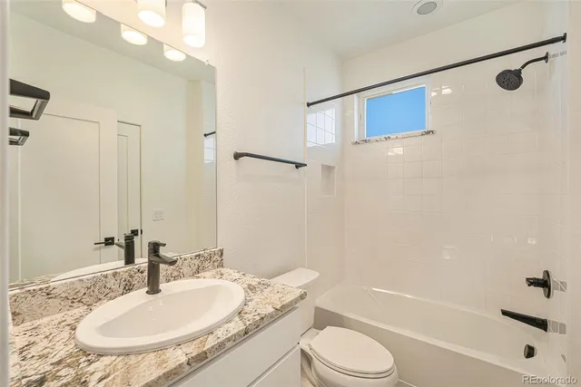 an empty room with wooden floor and a staircase