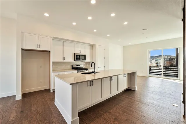 a view of kitchen with furniture and wooden floor