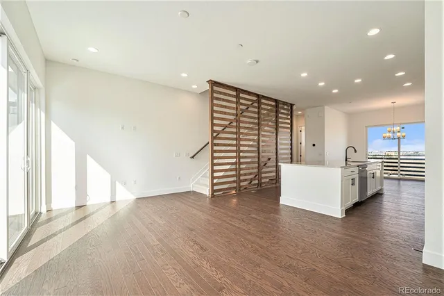 a view of a room with wooden floor and white walls