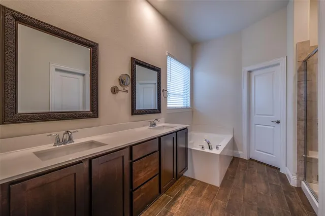 a bathroom with a toilet a sink a mirror and a window