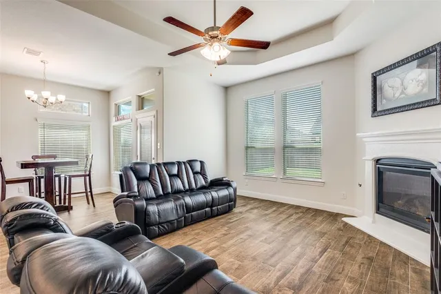 a living room with furniture ceiling fan and a fireplace