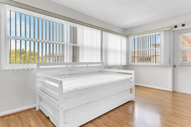 a room with a bed and a large window