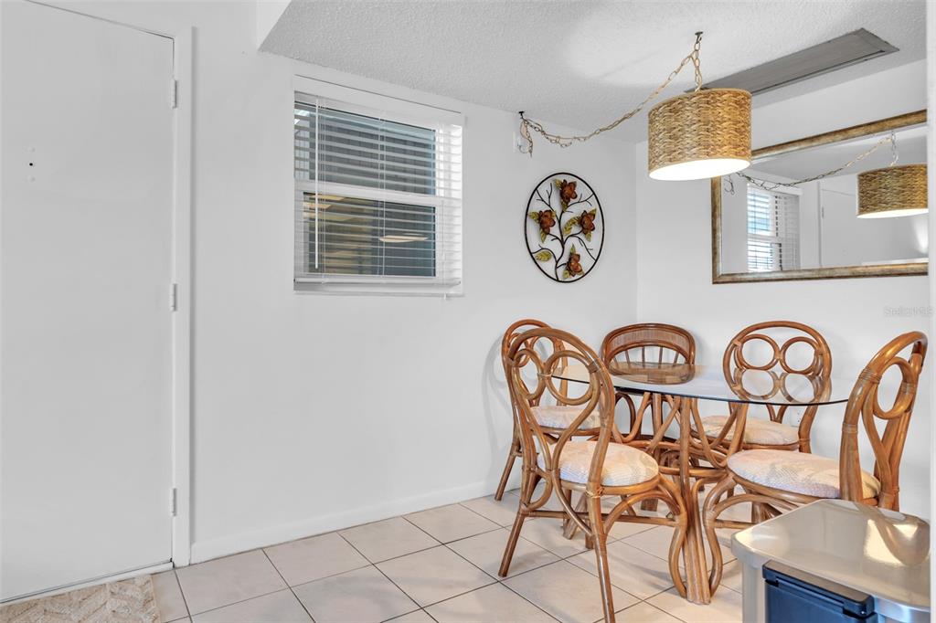 4743 Jasper Drive, Unit 204 New Port Richey, FL 34652 - Photo 5 of 17 a view of a dining room that has a table and a chair in it
