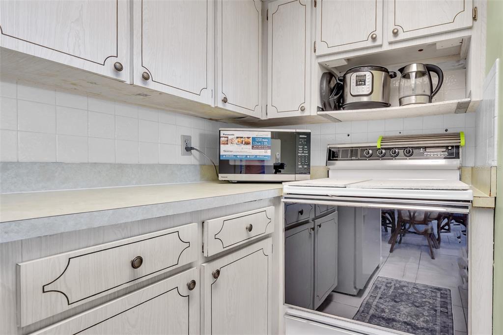 4743 Jasper Drive, Unit 204 New Port Richey, FL 34652 - Photo 7 of 17 a kitchen with a stove and cabinets