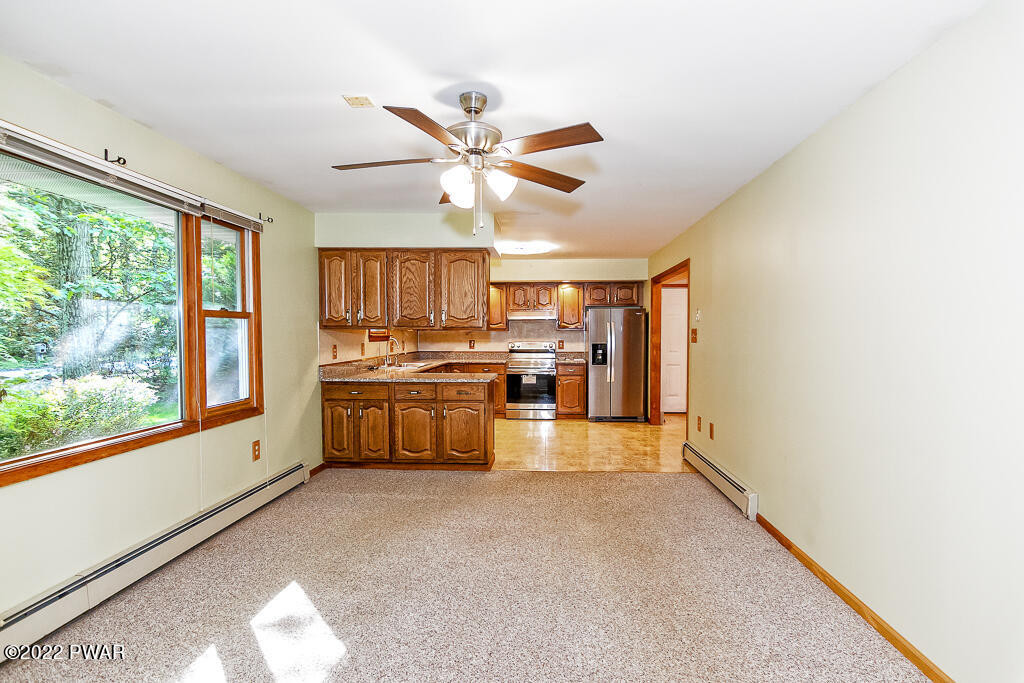 166 Devils Hole Road Cresco, PA 18326 - Photo 11 of 46 a kitchen with stainless steel appliances a lot of counter top space and a window