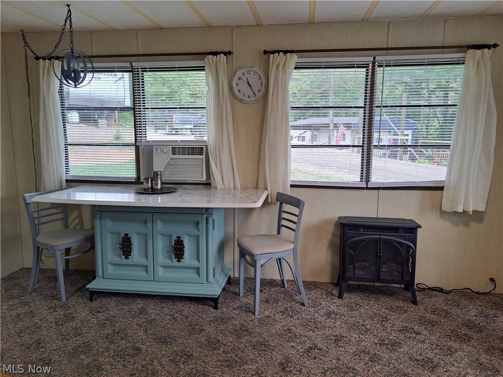 17875 Lashley Road, Unit 124 Senecaville, OH 43780 - Photo 24 of 45 Dining Room featuring carpet flooring, plenty of natural light, and a chandelier