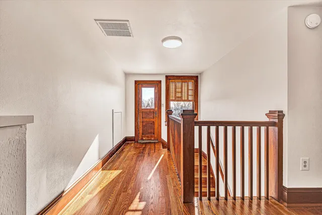 a view of a room with wooden floor and a window