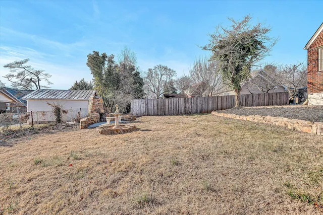 a view of a yard with a large tree