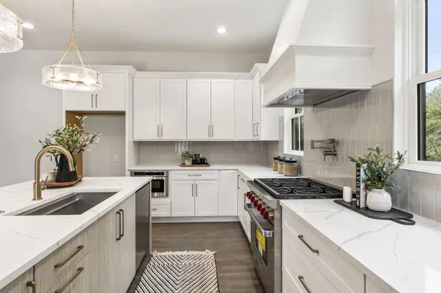 a kitchen with a stove cabinets and a sink