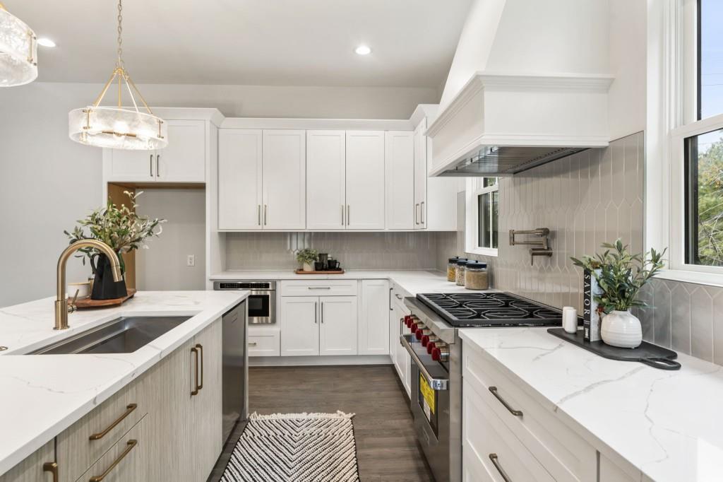 12455 Broadwell Road, Unit 201 Milton, GA 30004 - Photo 20 of 38 a kitchen with a stove cabinets and a sink
