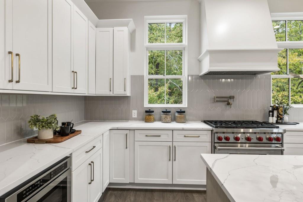 12455 Broadwell Road, Unit 201 Milton, GA 30004 - Photo 22 of 38 a kitchen with white cabinets and white appliances