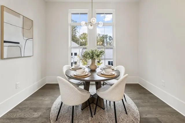 a view of a dining room with furniture and chandelier