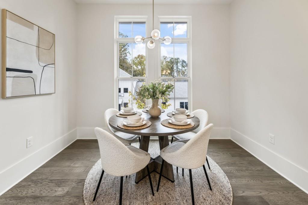 12455 Broadwell Road, Unit 201 Milton, GA 30004 - Photo 24 of 38 a view of a dining room with furniture and chandelier
