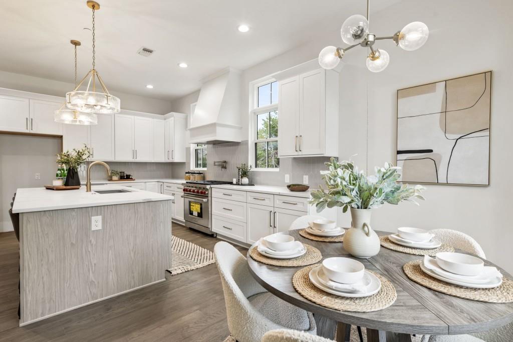 12455 Broadwell Road, Unit 201 Milton, GA 30004 - Photo 25 of 38 a kitchen with a dining table a sink stainless steel appliances and cabinets