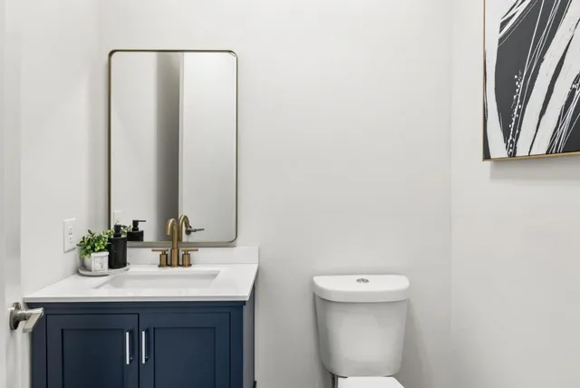 a bathroom with a toilet a sink and mirror