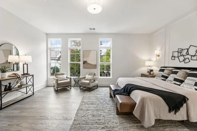 a bedroom with a bed couch and a window