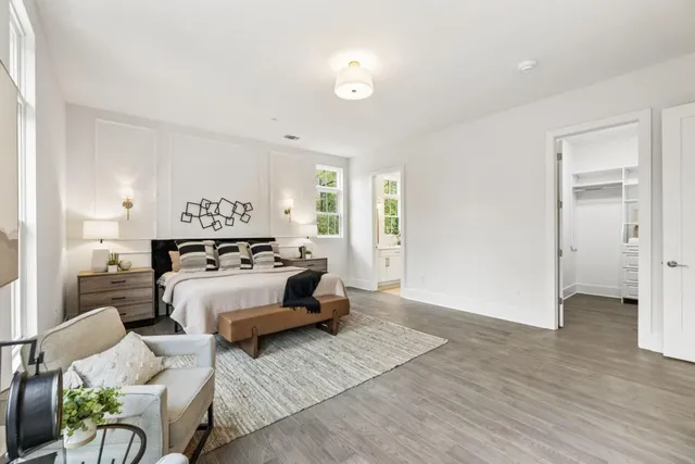 a bedroom with furniture and a lamp